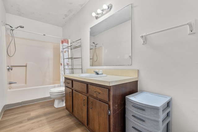 full bathroom featuring vanity, toilet, wood finished floors, and shower / bath combo with shower curtain