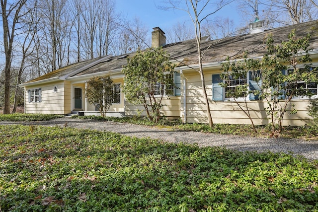 ranch-style home with a chimney