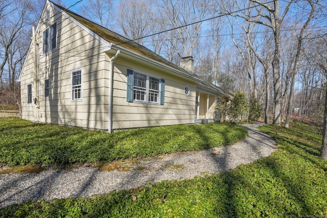 view of property exterior with a chimney