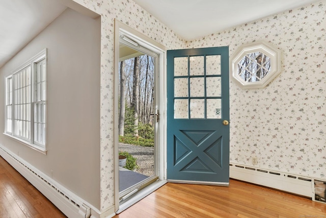 entryway featuring wallpapered walls, baseboard heating, and hardwood / wood-style floors