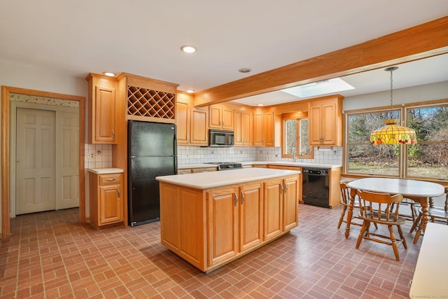 kitchen with black appliances, backsplash, recessed lighting, a skylight, and light countertops