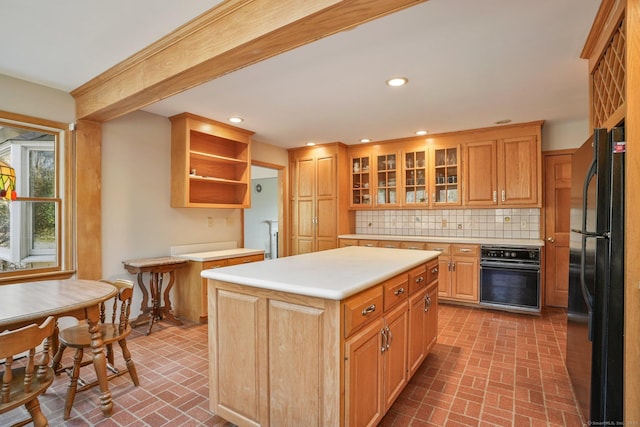 kitchen featuring black appliances, backsplash, recessed lighting, light countertops, and brick floor