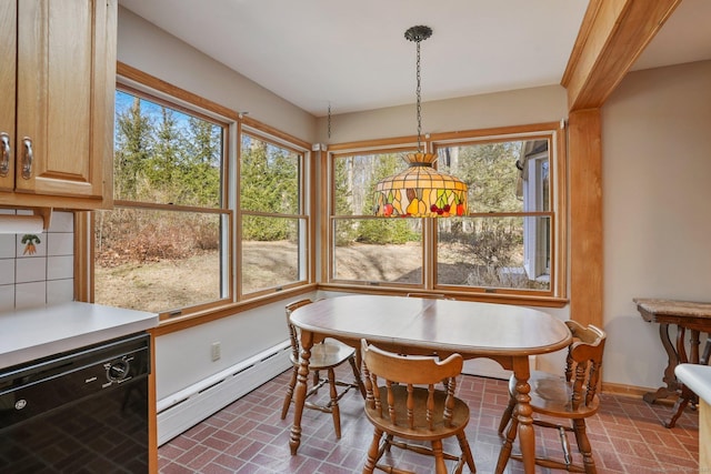 dining area featuring brick floor, baseboards, and a baseboard radiator