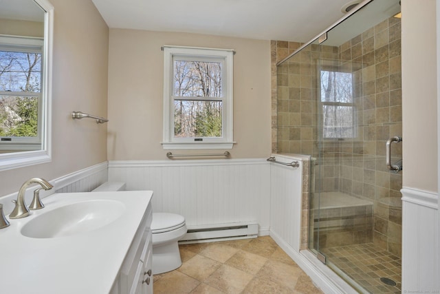 full bathroom featuring toilet, a stall shower, wainscoting, a baseboard radiator, and vanity