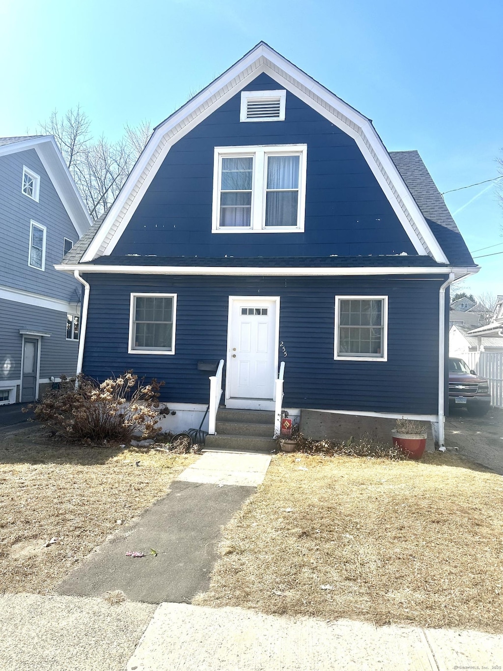 dutch colonial with a gambrel roof and entry steps