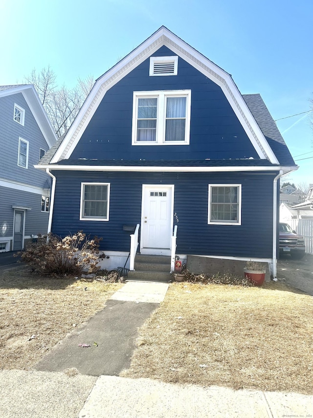 dutch colonial with a gambrel roof and entry steps