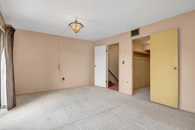 unfurnished bedroom with visible vents, carpet, and a closet