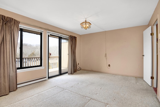 unfurnished room featuring a notable chandelier, carpet flooring, and a baseboard radiator