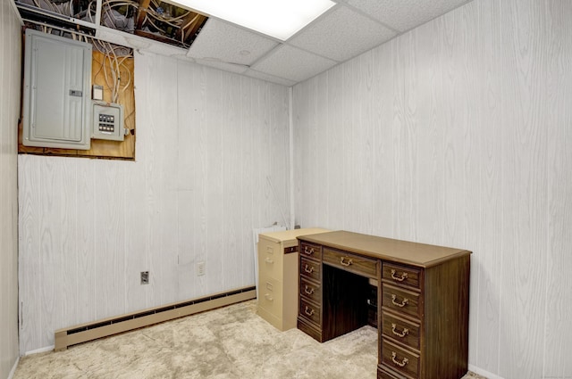 office space with electric panel, a drop ceiling, and a baseboard radiator