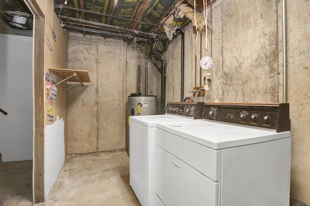 laundry room featuring laundry area, separate washer and dryer, and water heater