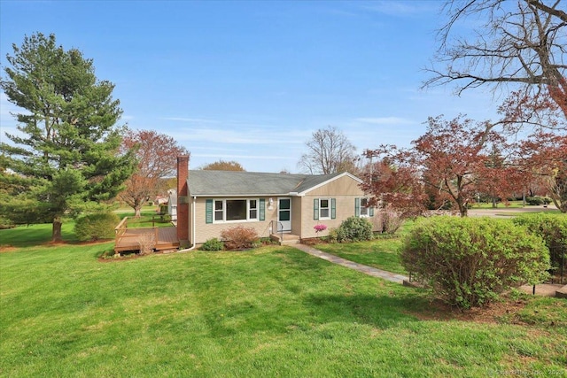 ranch-style home with a front lawn, a deck, and a chimney