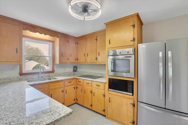 kitchen with a sink, ceiling fan, and appliances with stainless steel finishes