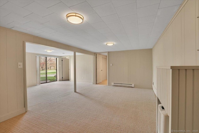 below grade area with a baseboard radiator and light carpet