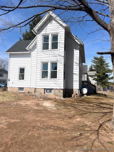 view of property exterior featuring roof with shingles