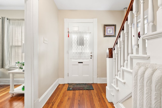 entrance foyer featuring stairway, baseboards, and hardwood / wood-style flooring