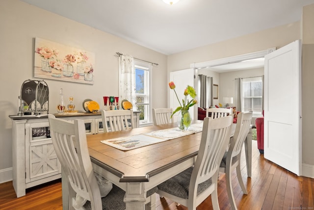 dining space featuring hardwood / wood-style flooring and baseboards