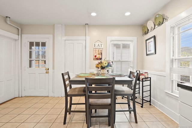 dining area featuring light tile patterned floors, recessed lighting, and wainscoting