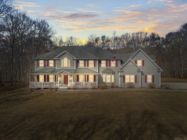 view of front facade with covered porch and a front lawn