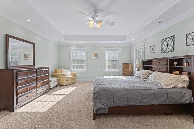 carpeted bedroom featuring a raised ceiling, recessed lighting, and crown molding