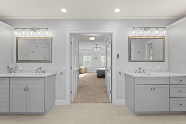 bathroom with a sink, baseboards, two vanities, and recessed lighting