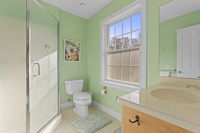 full bath featuring toilet, a stall shower, tile patterned flooring, baseboards, and vanity