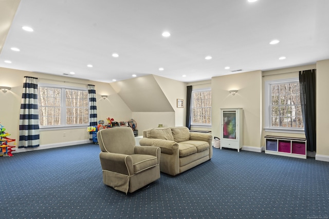 living room with plenty of natural light, visible vents, baseboards, and carpet floors