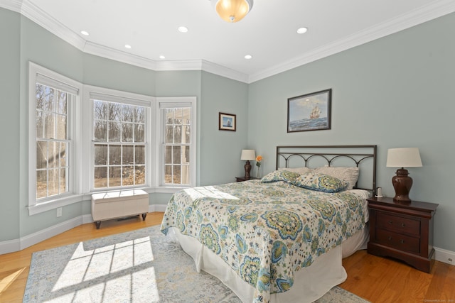 bedroom featuring recessed lighting, baseboards, wood finished floors, and crown molding