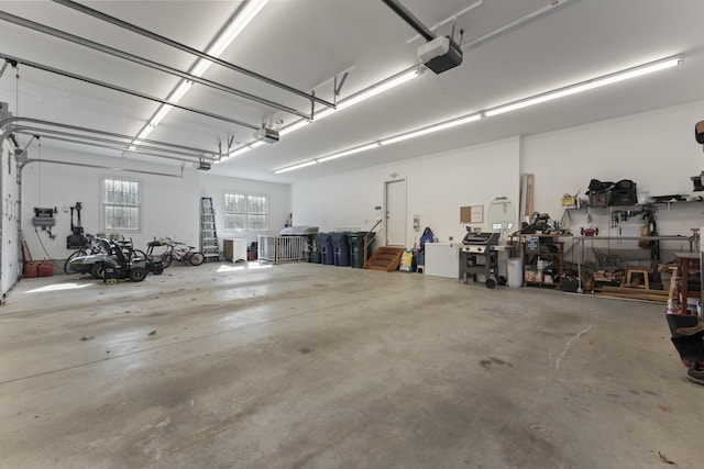 garage with a workshop area and a garage door opener