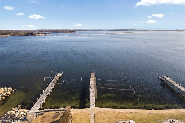 dock area with boat lift and a water view