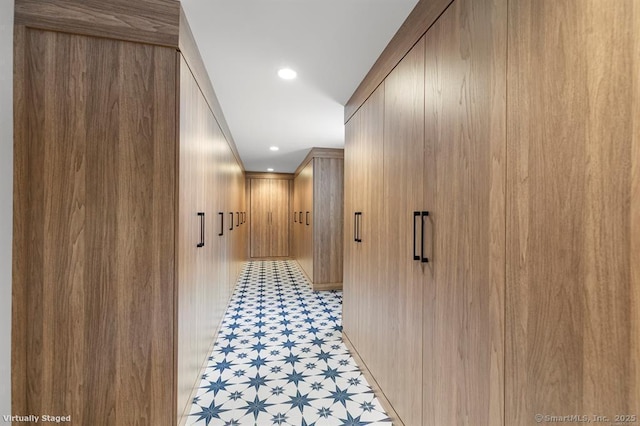 hall with recessed lighting and light floors