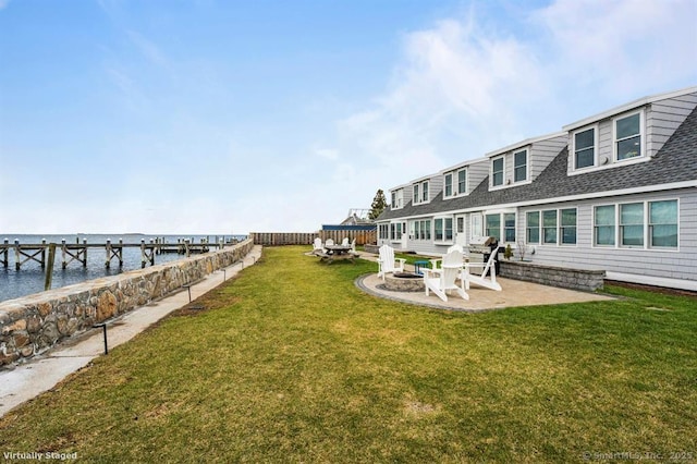 view of yard with a patio area, a fire pit, and a water view