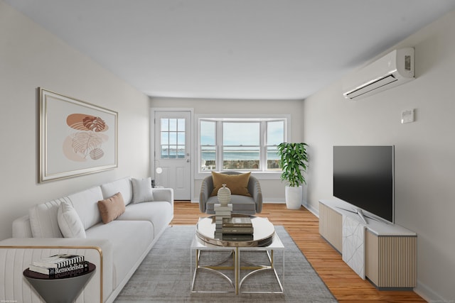 living area with light wood-style flooring, baseboards, and a wall mounted air conditioner