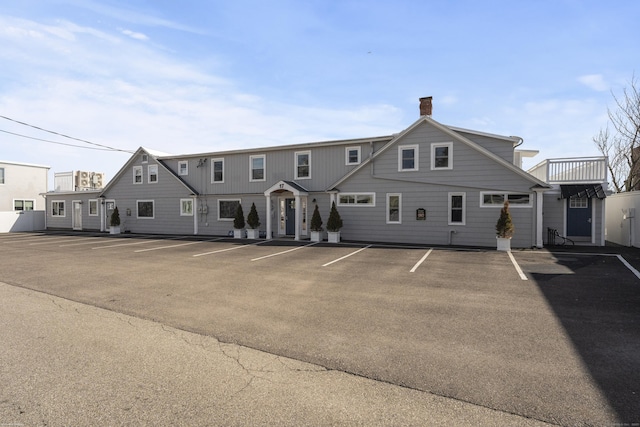 view of building exterior featuring uncovered parking