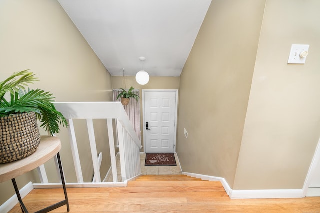 interior space featuring baseboards and wood finished floors