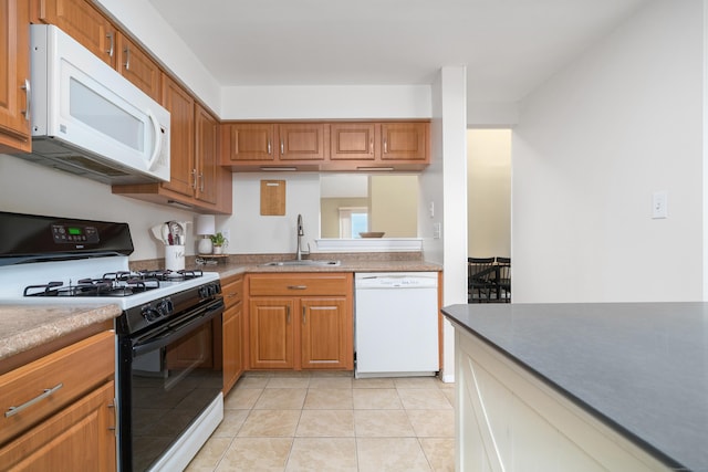 kitchen featuring a sink, white appliances, brown cabinets, and light tile patterned floors