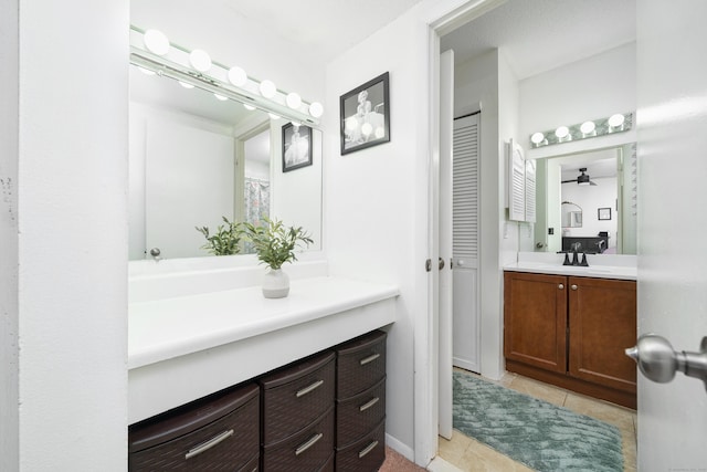 bathroom featuring vanity, a ceiling fan, a closet, and tile patterned flooring