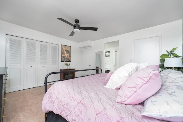 bedroom with a closet, ceiling fan, connected bathroom, and carpet