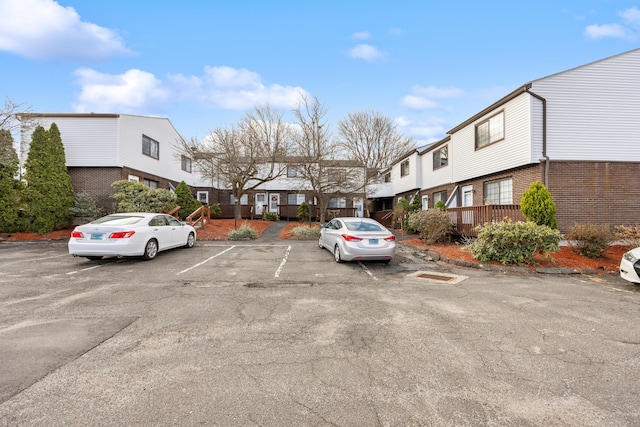 uncovered parking lot featuring a residential view