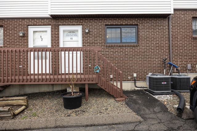 exterior space featuring brick siding and central AC