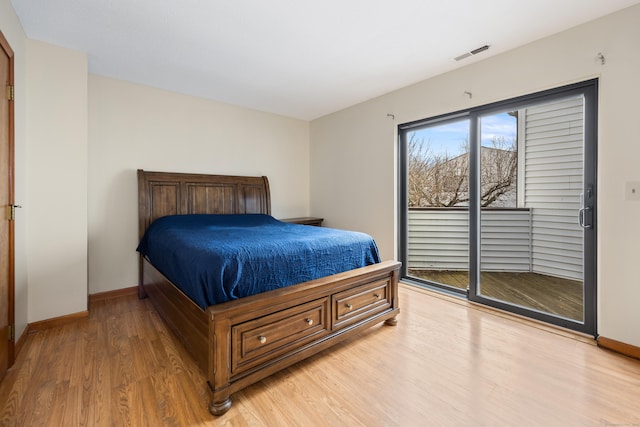 bedroom featuring access to exterior, light wood finished floors, baseboards, and visible vents