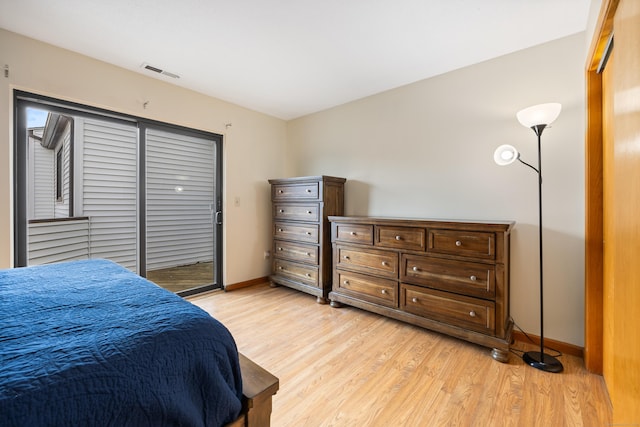 bedroom with light wood finished floors, baseboards, visible vents, and access to outside
