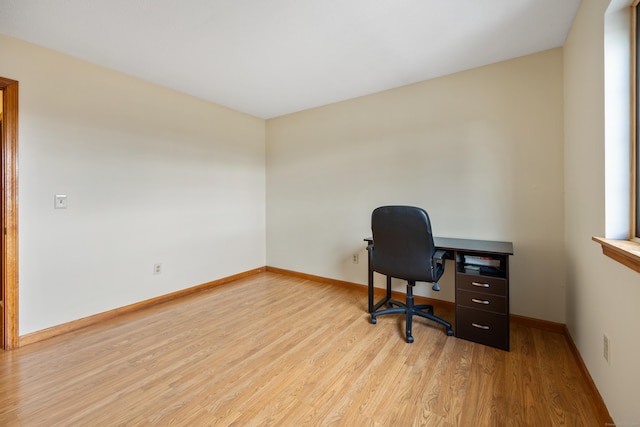office featuring baseboards and light wood finished floors