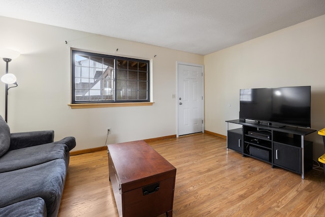 living area featuring light wood finished floors and baseboards