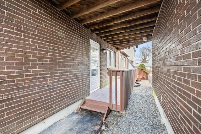 view of home's exterior with brick siding and a deck