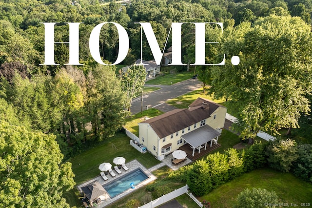 birds eye view of property with a view of trees