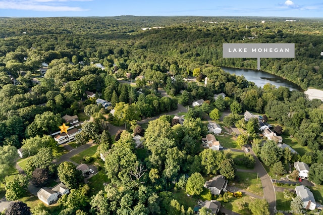 bird's eye view with a forest view and a water view