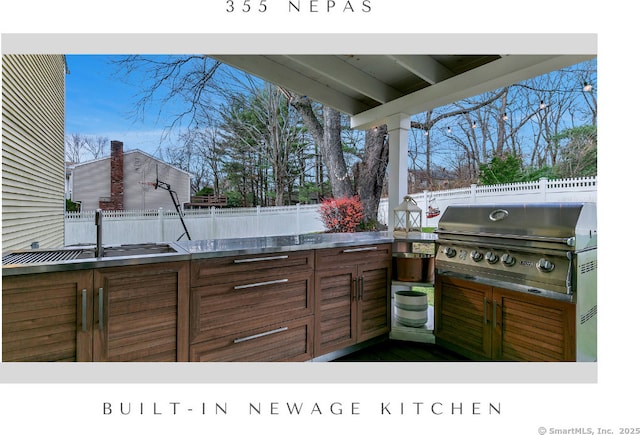 view of patio with a sink, grilling area, area for grilling, and a fenced backyard