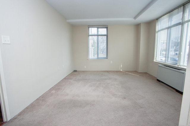 carpeted empty room with radiator