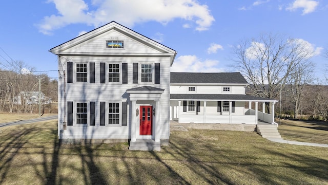 neoclassical / greek revival house featuring covered porch and a front lawn