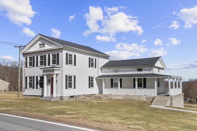 view of front of home with a porch, a front lawn, and a shingled roof